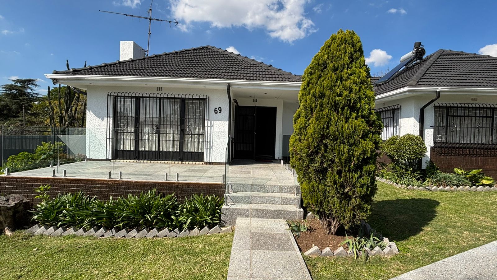 Front entrance steps, patio, and garden beds