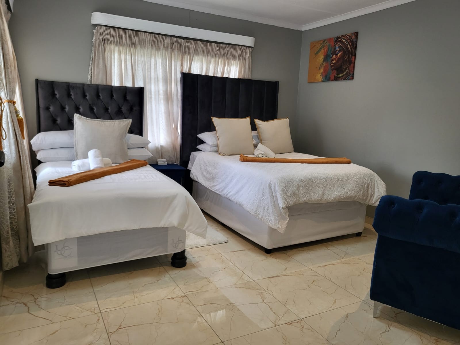 Wide view of Room 1 with double and single beds