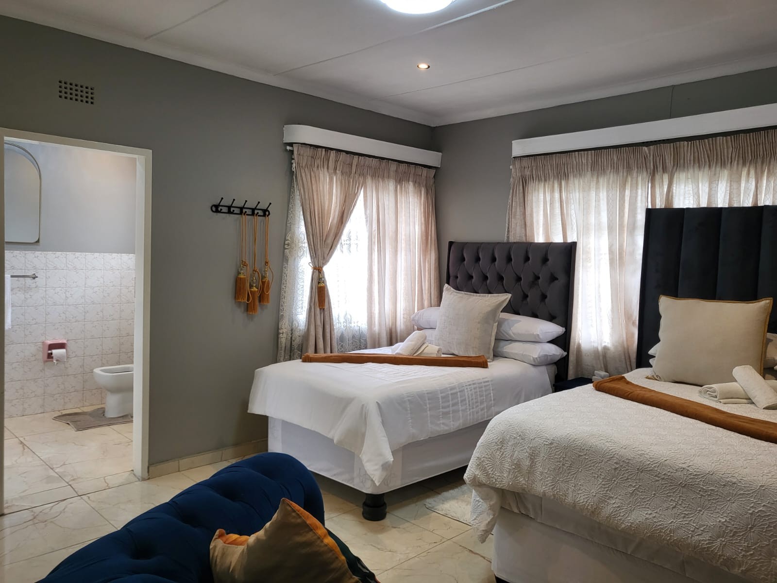 Room 1 with a double bed, single bed, and en suite bathroom